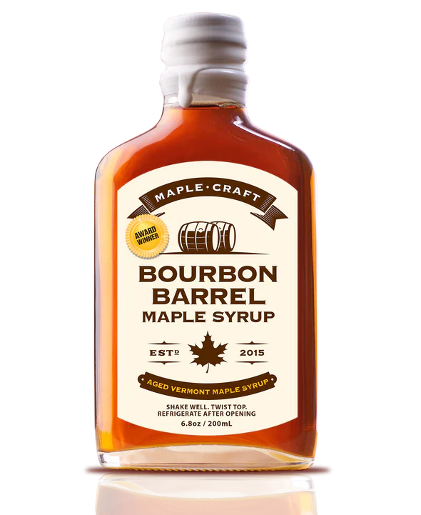 Bottle of Bourbon Barrel Maple Syrup with a white label on a white background